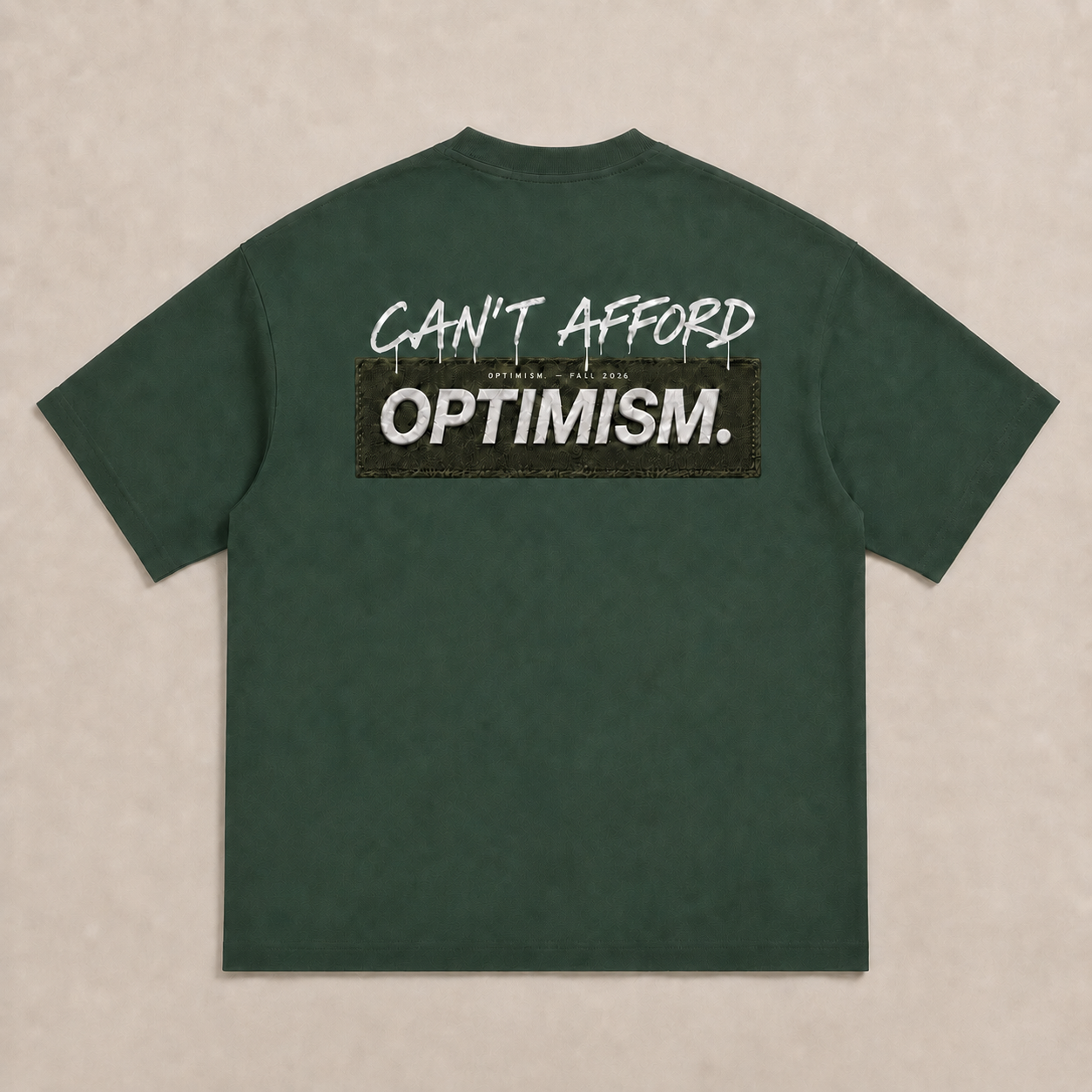 Back of the Private Green OPTIMISM. T-shirt featuring Can't Afford script and detailed printed patch-effect graphic.