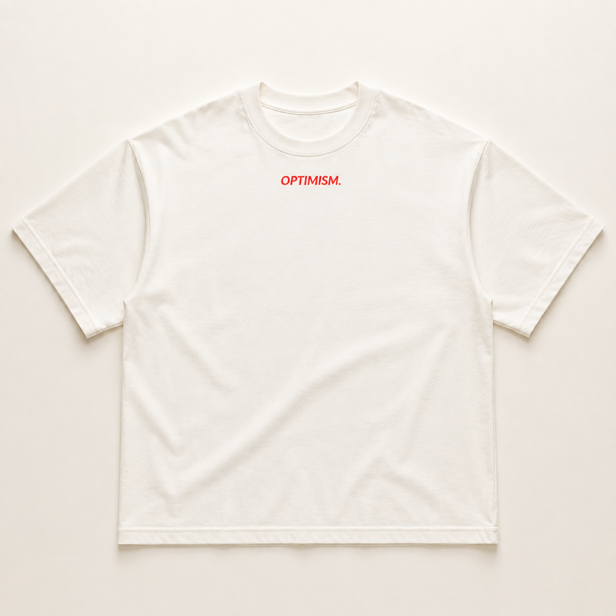 Front of the bone-white oversized OPTIMISM. tee with a small red chest mark.