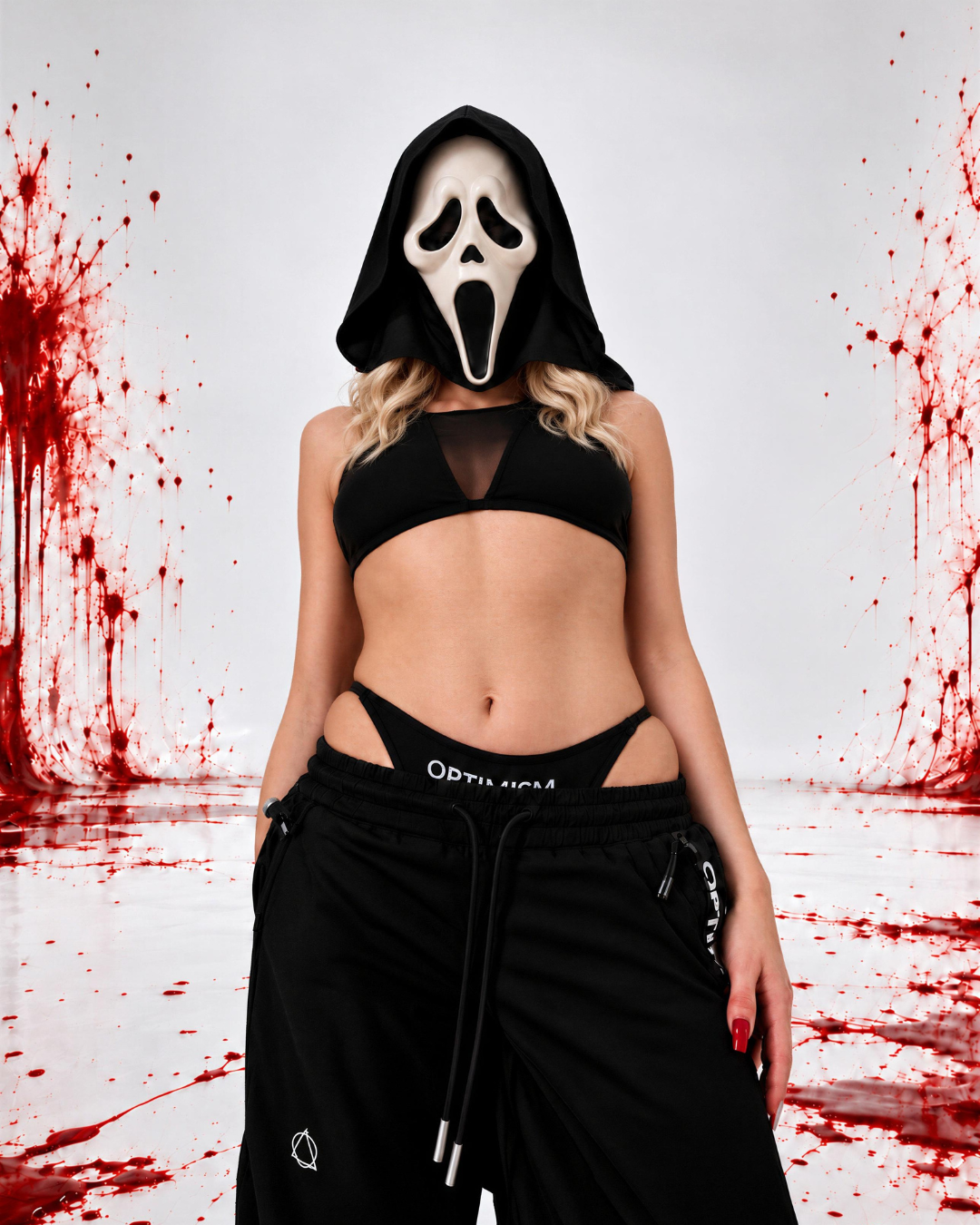 OPTIMISM. Late Fall Her — hooded model in black mesh-panel top and black OPTIMISM. drawstring trousers