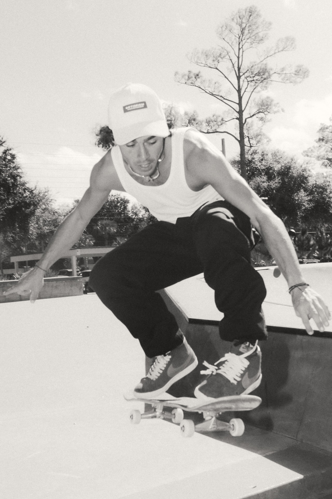 OPTIMISM. archive — Cap and tank at the park. Airborne, mid-frame.
