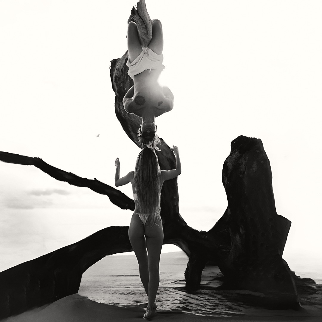 Driftwood study. Two figures at the edge of the water.