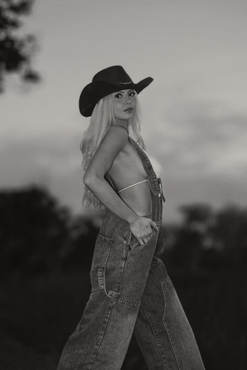 Denim overall at dusk. Open sky, single figure.