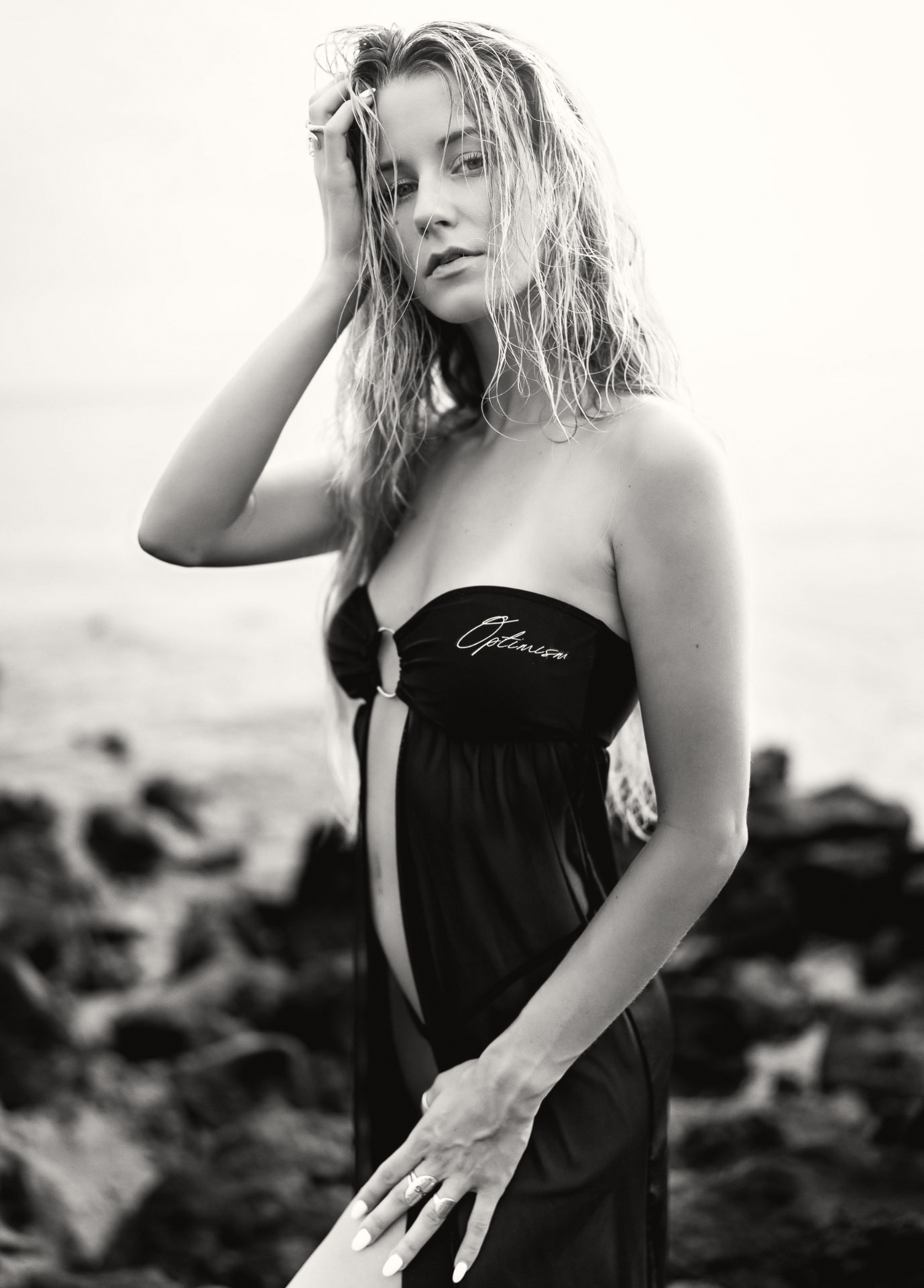 OPTIMISM. archive — Black set at the shoreline. The season returns to open air.