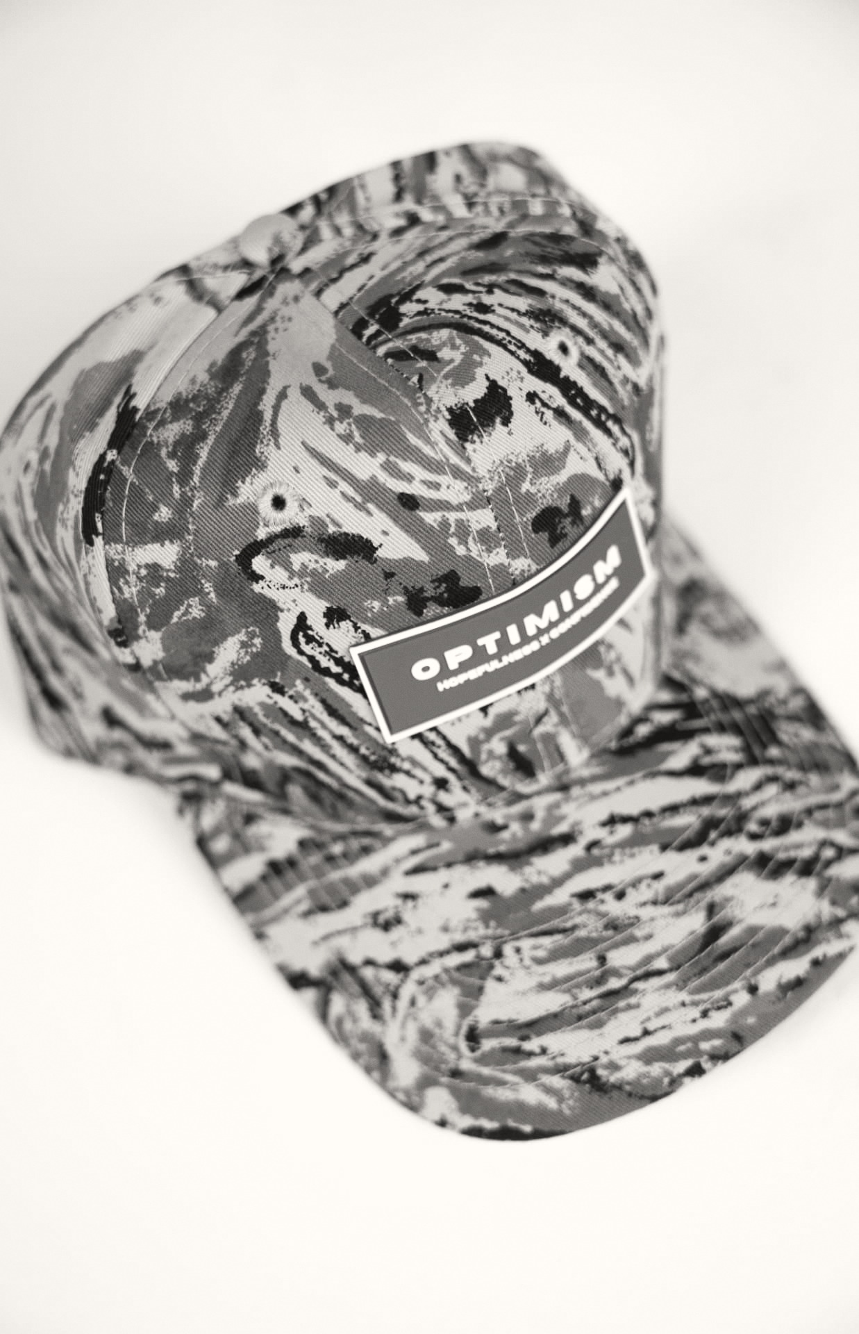 OPTIMISM. archive — Camouflage cap. Object study, red plate at the crown.