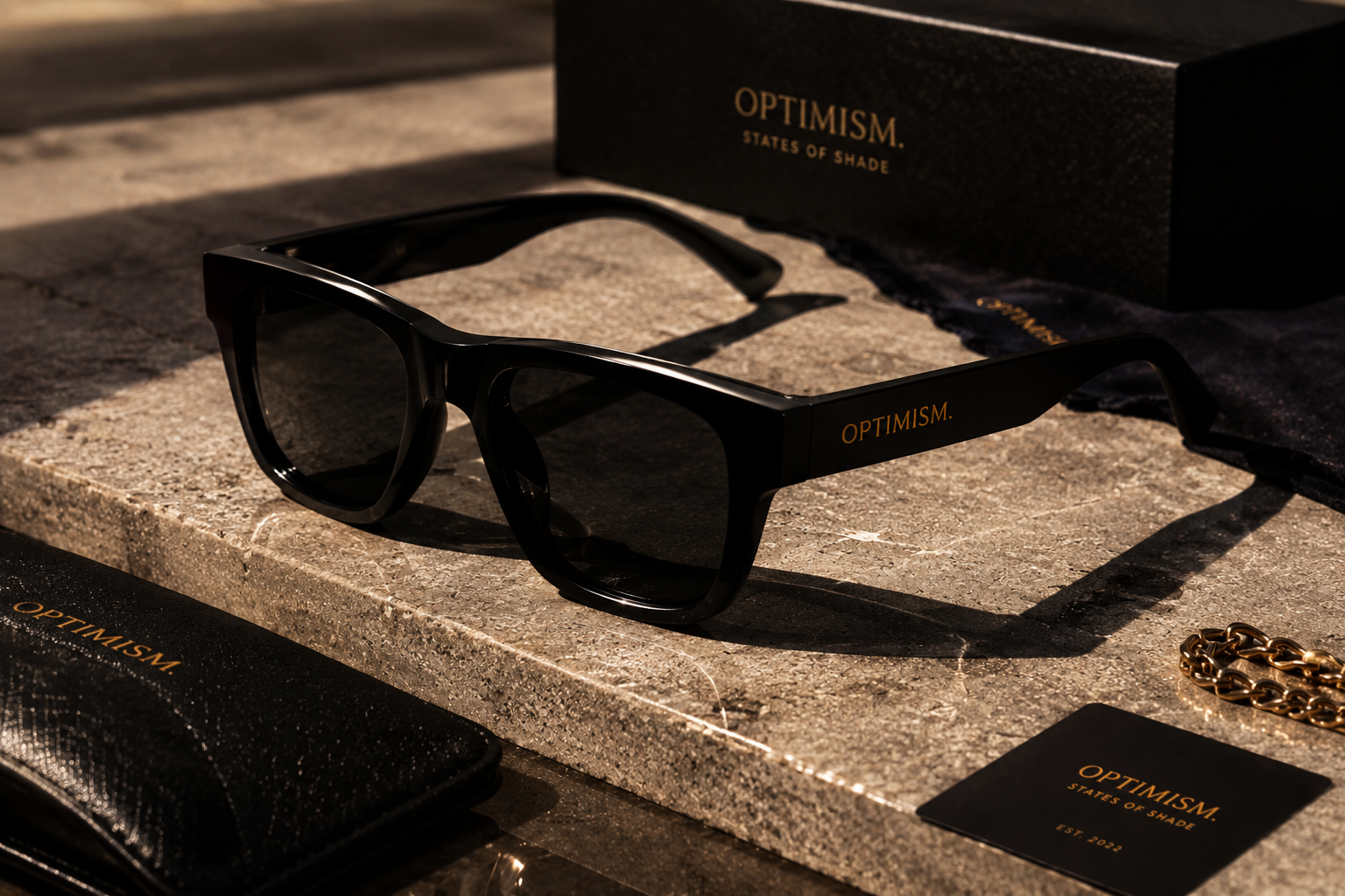 States of Shade black acetate frame with collector packaging on travertine stone